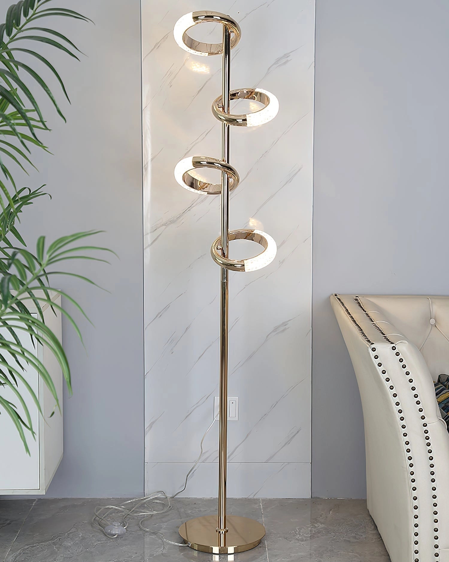 Gold Diamond-Patterned Adjustable Angles Floor Lamp in a modern interior setting with wooden flooring, a plant, and art on the walls.
