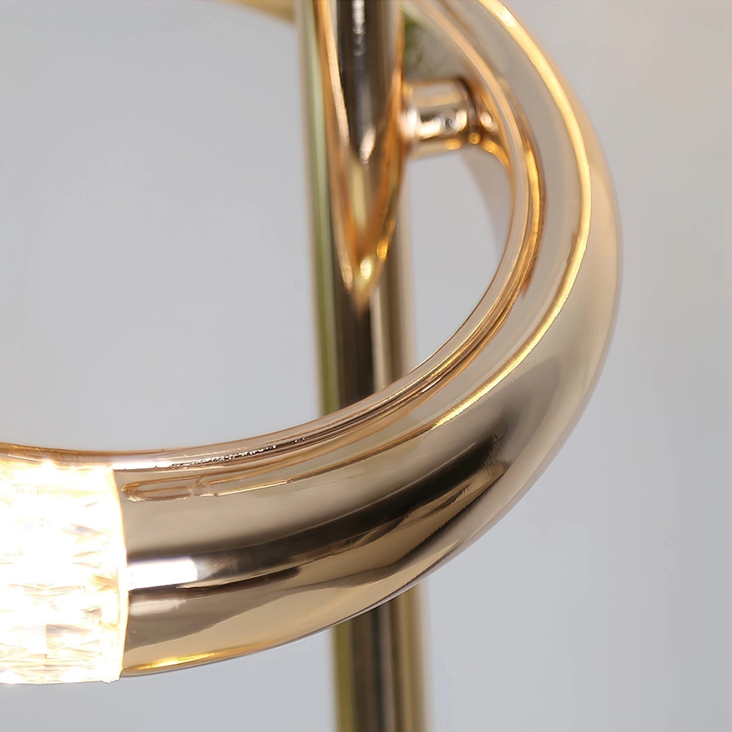 Gold diamond-patterned adjustable angles floor lamp with a sleek metal and wood design, featuring a circular base and a glass shade.