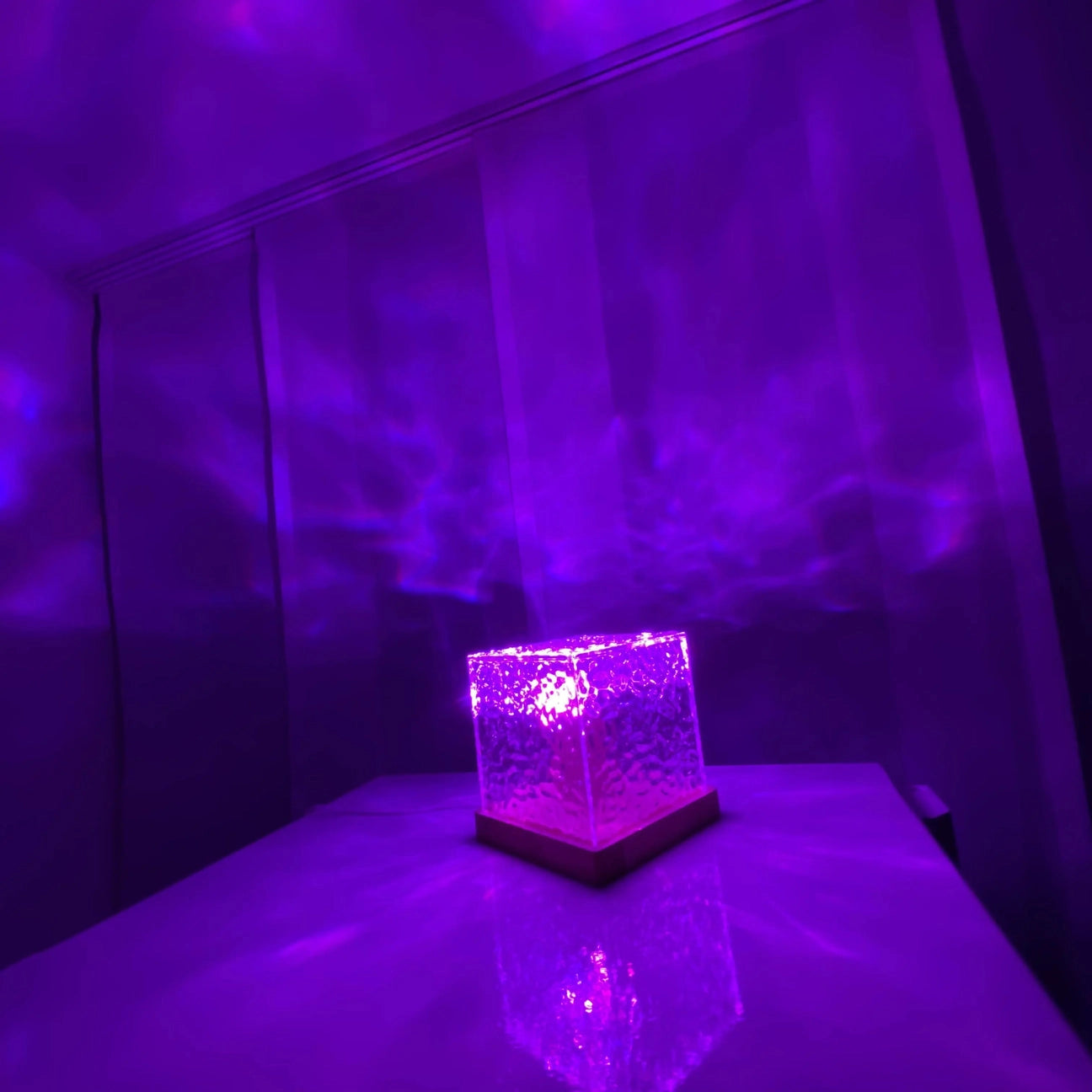 A rectangular purple and magenta table nightstand nightlight with visual effect lighting, suitable for interiors and entertainment events.