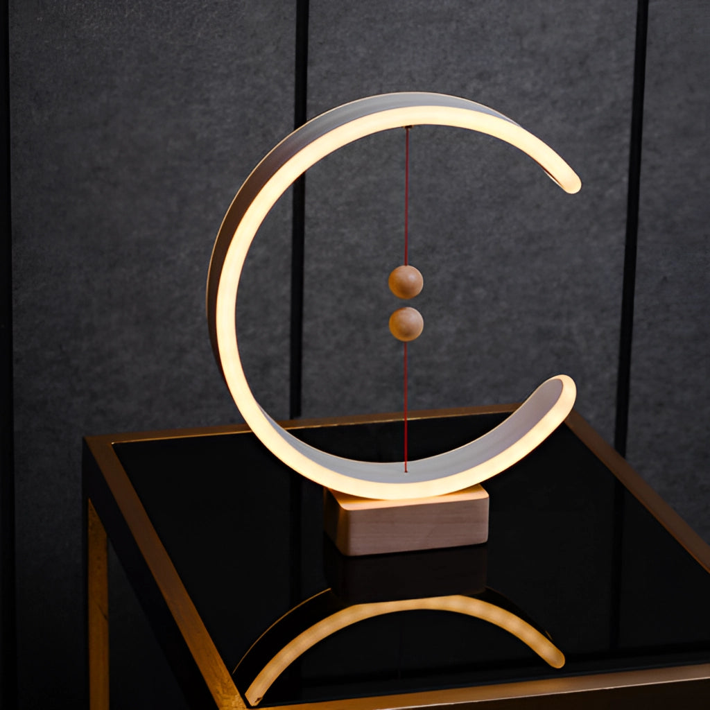 Interior lamp with magnetic switches, featuring a crescent-shaped glow, wooden rectangular base, and metal accents.