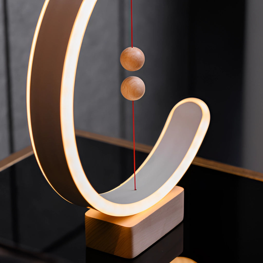 Interior lamp with magnetic switches featuring a crescent-shaped glow, designed with a combination of wood and metal materials, showcasing artistic rectangular and circular elements.