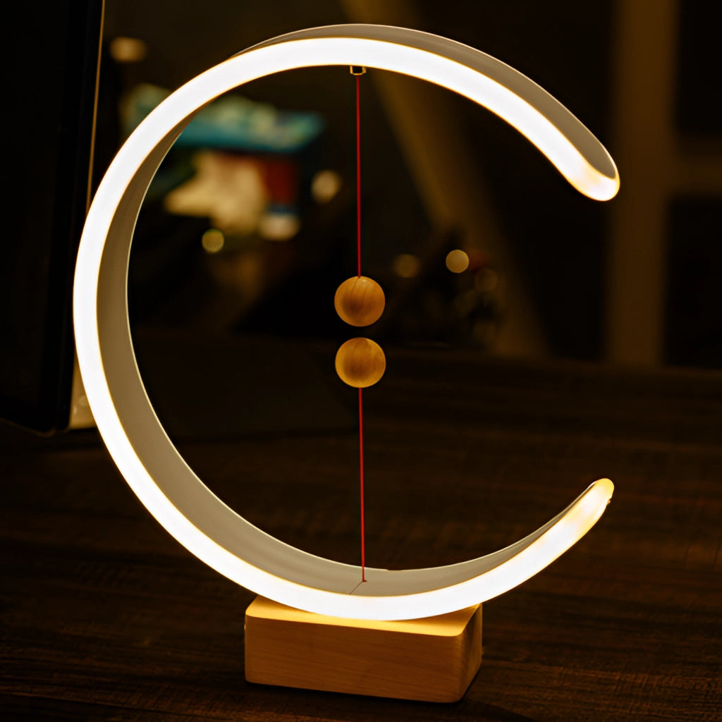 Interior lamp featuring a crescent-shaped glow with magnetic switches, wooden base, and metal accents.