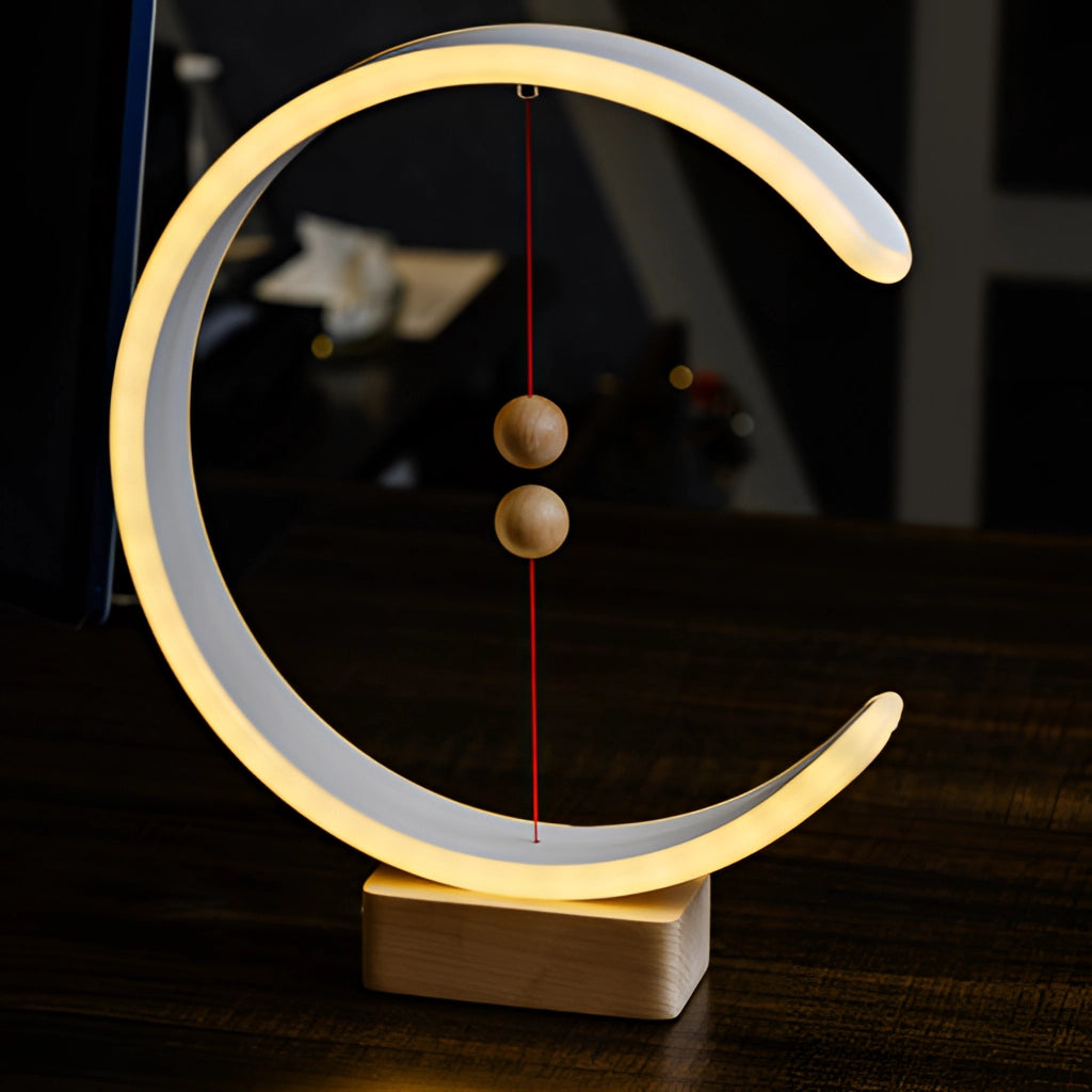 Interior lamp with magnetic switches and crescent-shaped glow, featuring a wooden base and metal accents.
