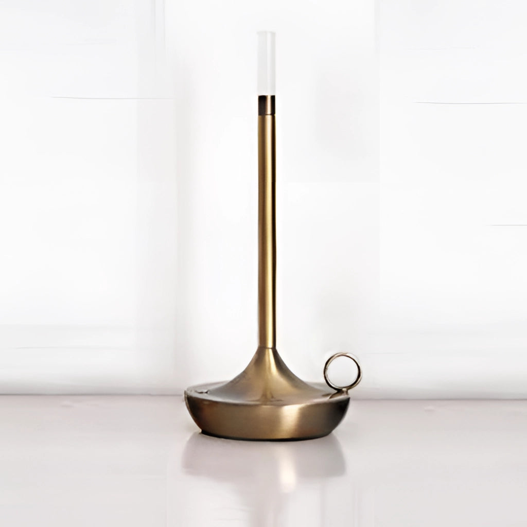 Iron Lamp with Unique Candle Design and 3-Level Dimming Option in Copper finish displayed on a modern wooden table, surrounded by chairs in a contemporary interior setting.