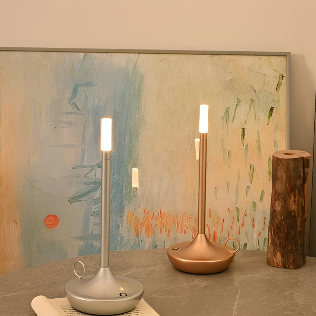 Iron lamp with unique candle design, featuring 3-level dimming option, placed on a wooden table in a well-designed interior space with artistic elements and painted surfaces.