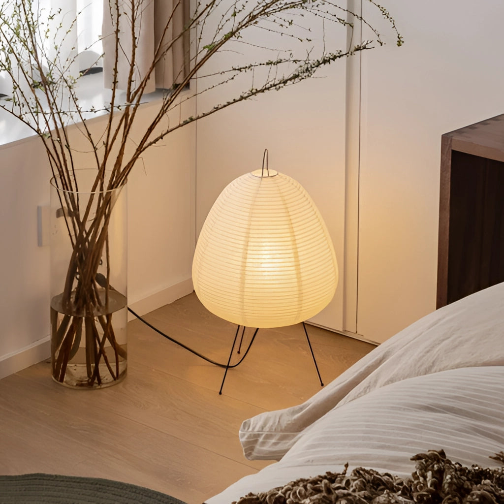 Japanese Rice Paper Table Lamp with wooden base, emitting a soft glow, enhancing comfort and interior design aesthetics in a modern room.