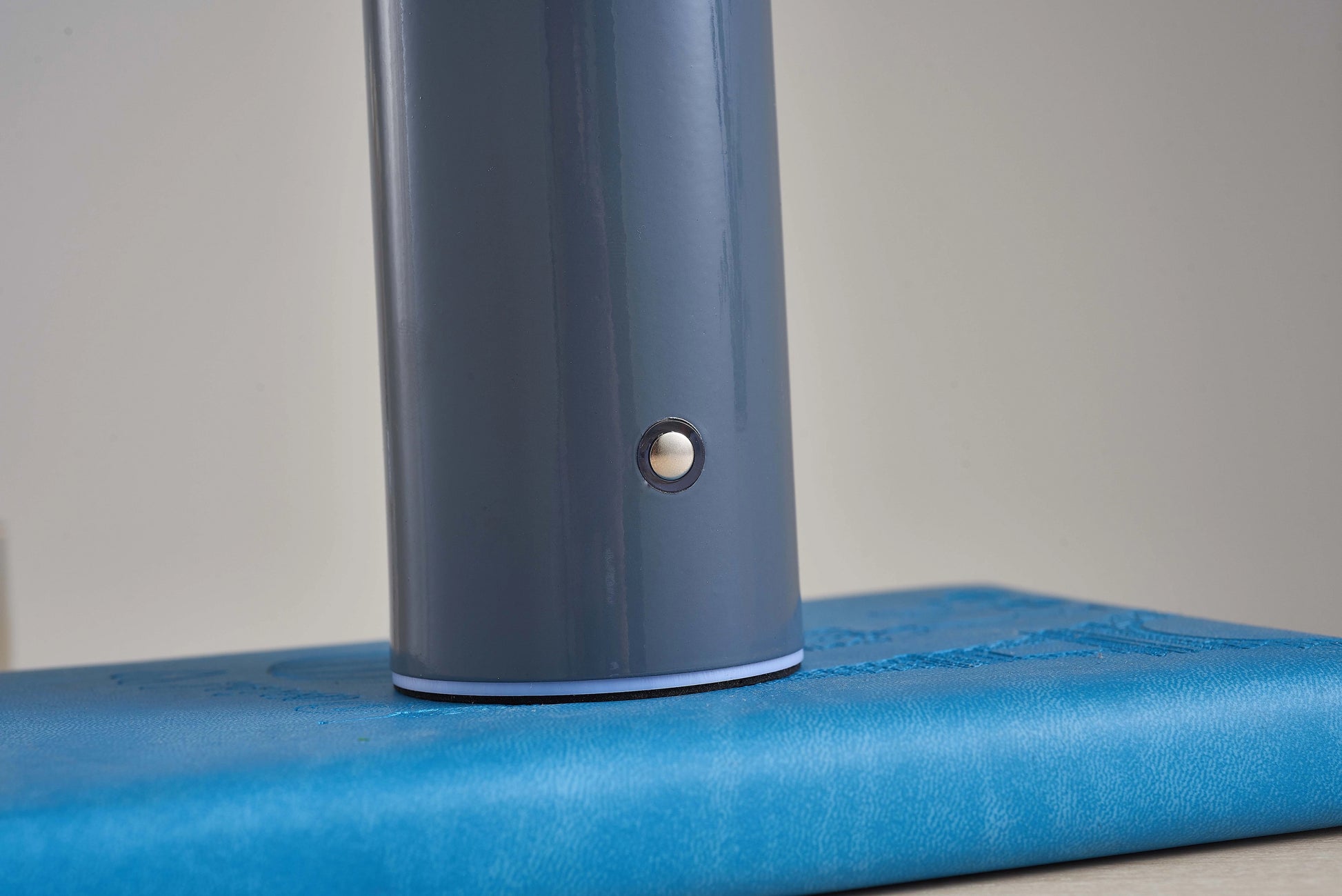 LED cordless table lamp with unique mushroom design in electric blue color, featuring a sleek cylindrical body and metallic accents.