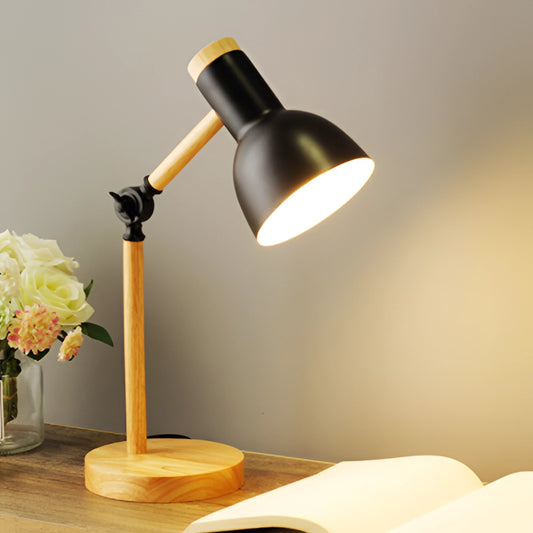 Black LED desk lamp with Scandinavian minimalist design, featuring energy-efficient lighting and a switch for 3 color settings. Lamp is placed on a wooden surface near a yellow rose and orange flower.