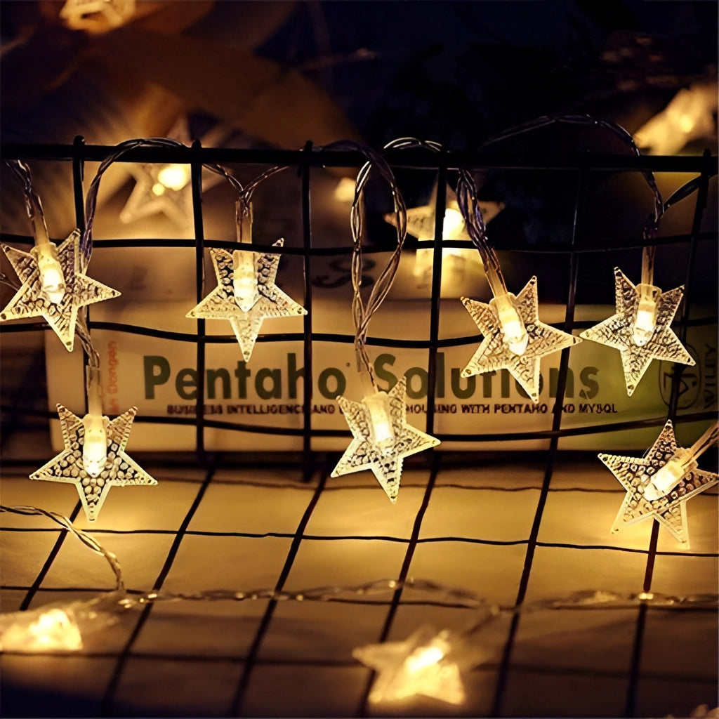 Warm white LED fairy string lights in star shape, 10 meters long with 100 LEDs plugged in, creating a twinkling, romantic ambiance.