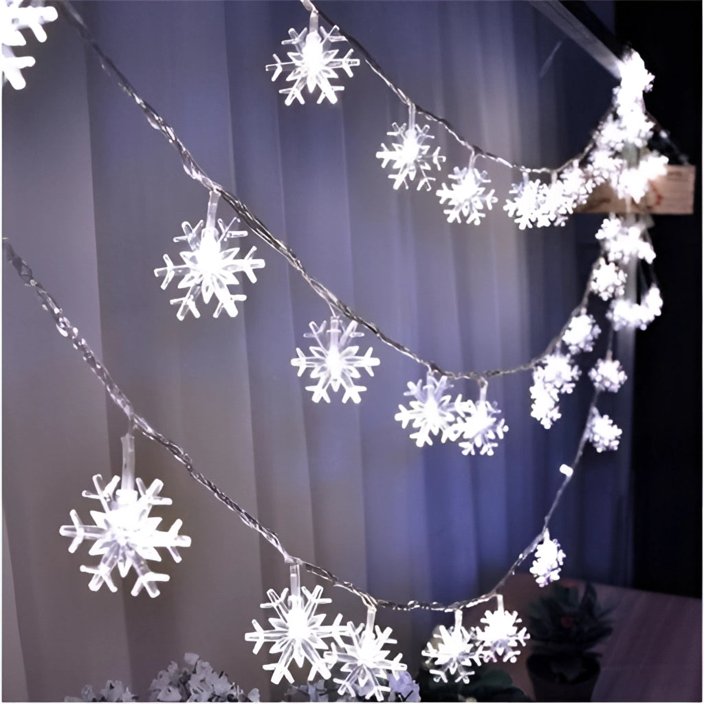 Warm white LED fairy string lights with snowflake design, 10 meters long with 100 LEDs, creating a twinkling magical ambiance, perfect for romantic settings and Christmas decoration.