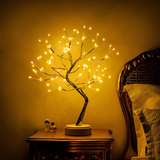 Three LED Fairy Tree Lights with 108 Mini LEDs, arranged on a table, emitting a warm amber-orange glow. The lights are shaped like trees with natural twig and wood-like features.