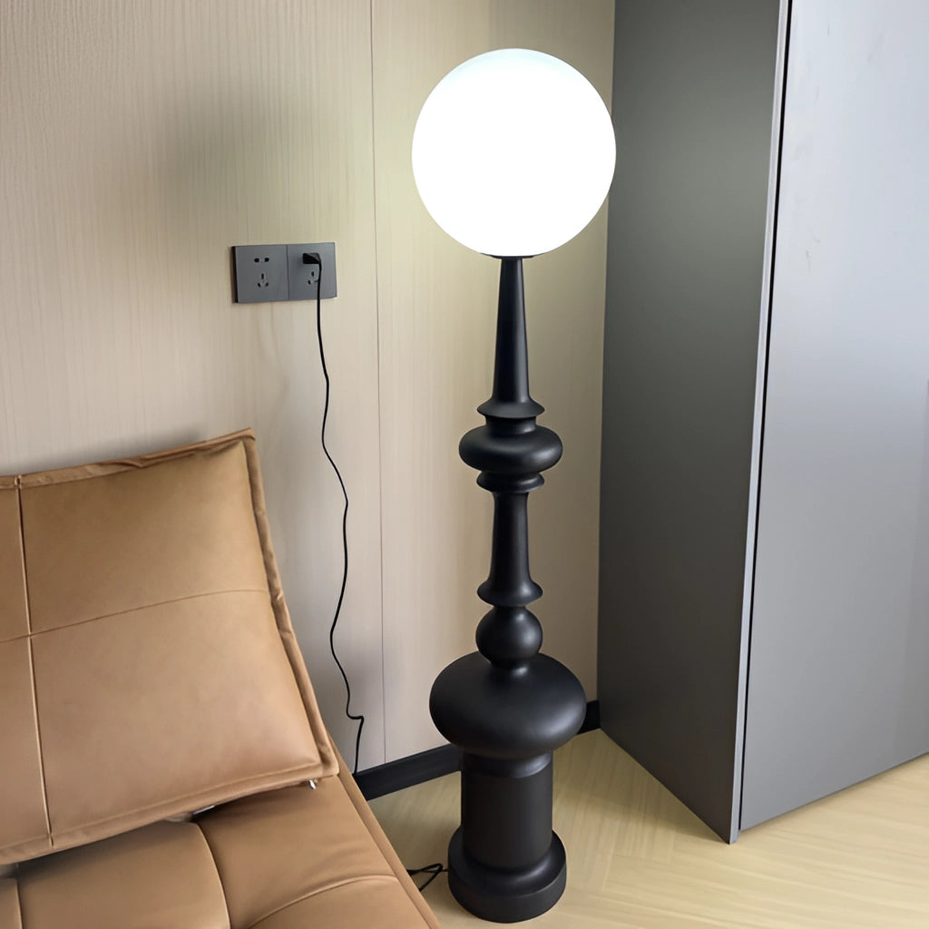 LED floor lamp with wooden base, featuring adjustable lighting modes, standing on a hardwood floor near a comfortable armchair.