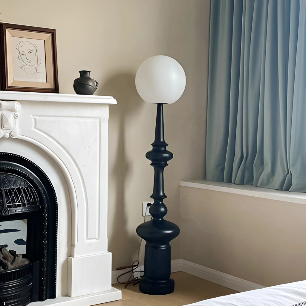 LED floor lamp in a modern living room with hardwood flooring and picture frames on the wall.