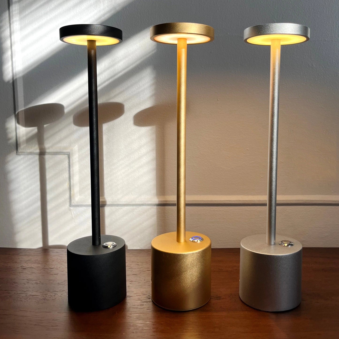 LED Portable Table Lamp with Resilient Design featuring a cylindrical wooden base and circular light, placed on wooden flooring.
