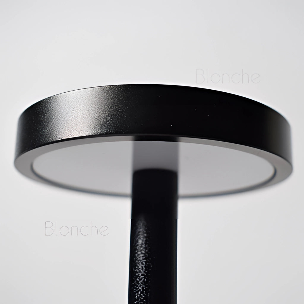 LED Portable Table Lamp with Resilient Design in metallic silver finish featuring a circular base.