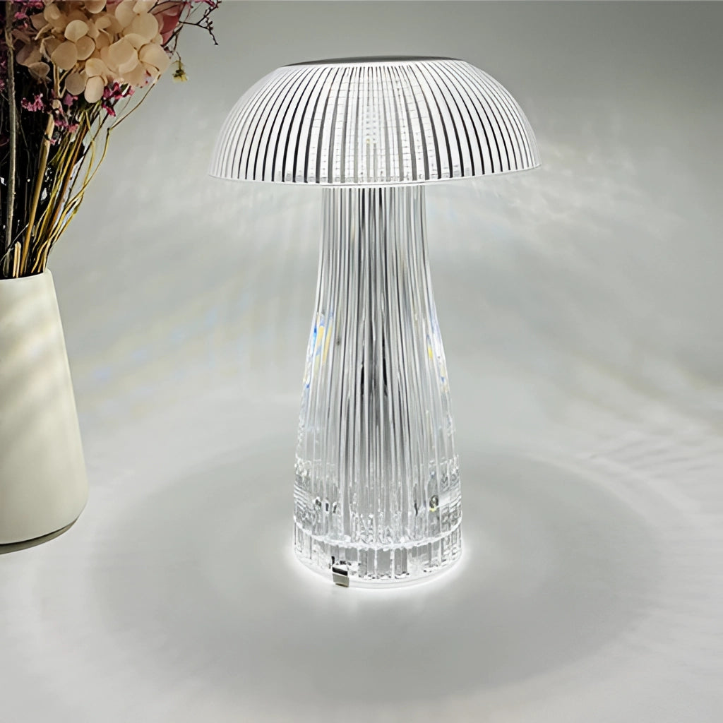 LED table lamp with steepless dimming and large battery placed on a wooden table beside drinkware and tableware, with plants and decorative art in the background.