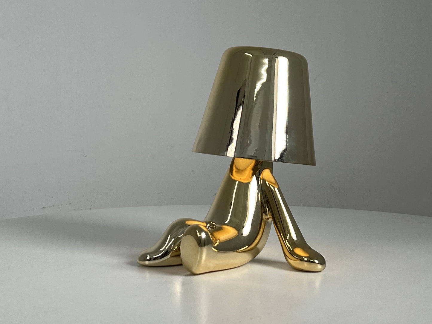 LED table lamp with unique design featuring high-quality materials, including wood and metal, styled as an artistic piece on a table.