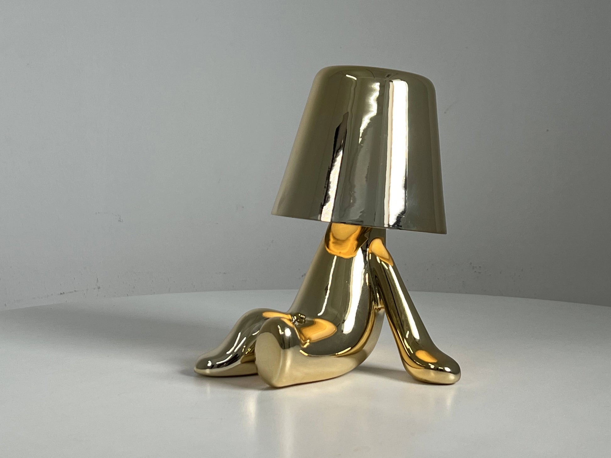 LED table lamp with unique design featuring high-quality materials, including wood and metal, styled as an artistic piece on a table.