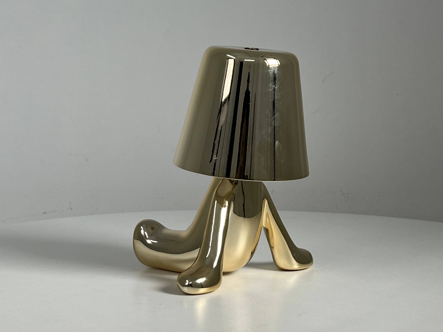 LED table lamp with unique design on a wooden table, featuring a modern lampshade and artistic elements in a stylish setting.