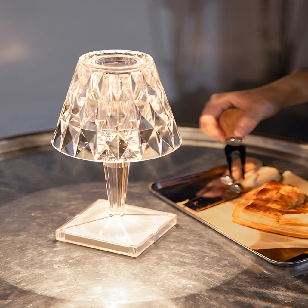 LED touch table lamp with USB charging on a wooden table with tableware and plates.