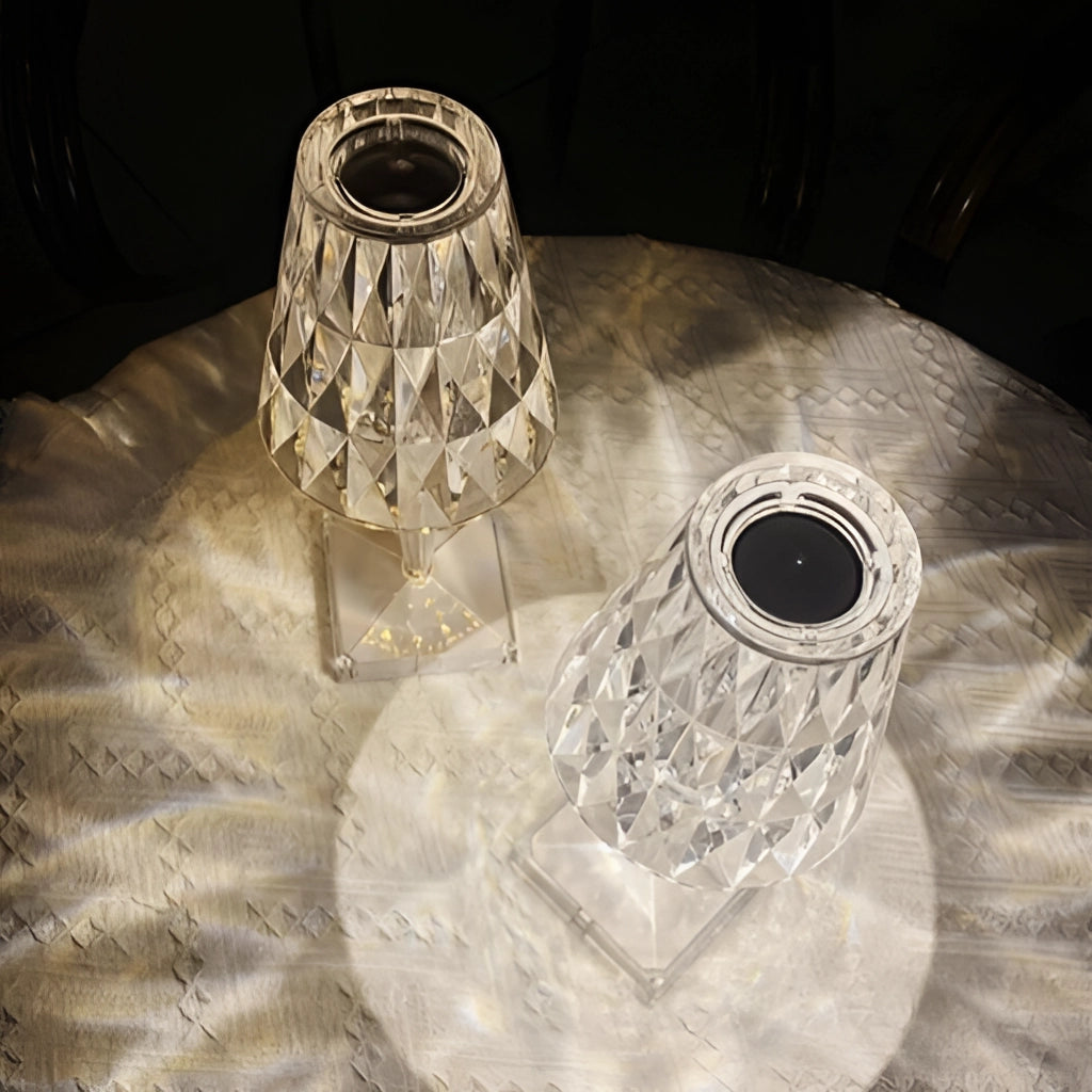 LED touch table lamp with USB charging sitting on a wooden table next to glass drinkware and a doily, showcasing its mood-enhancing capabilities and unique design.