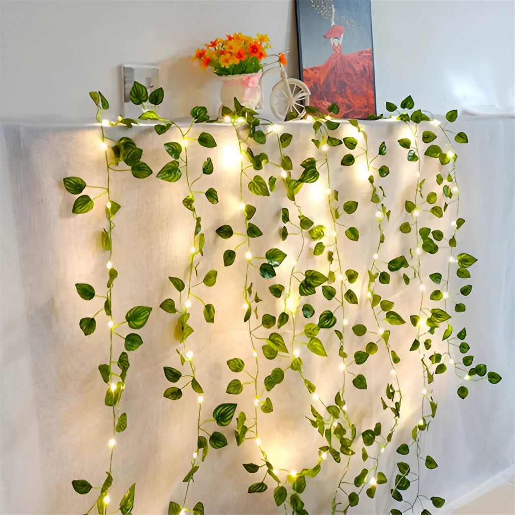 LED vine garden string lights with ivy vines, 32ft with 100 LEDs, creatively decorating a space with floral and leafy patterns.