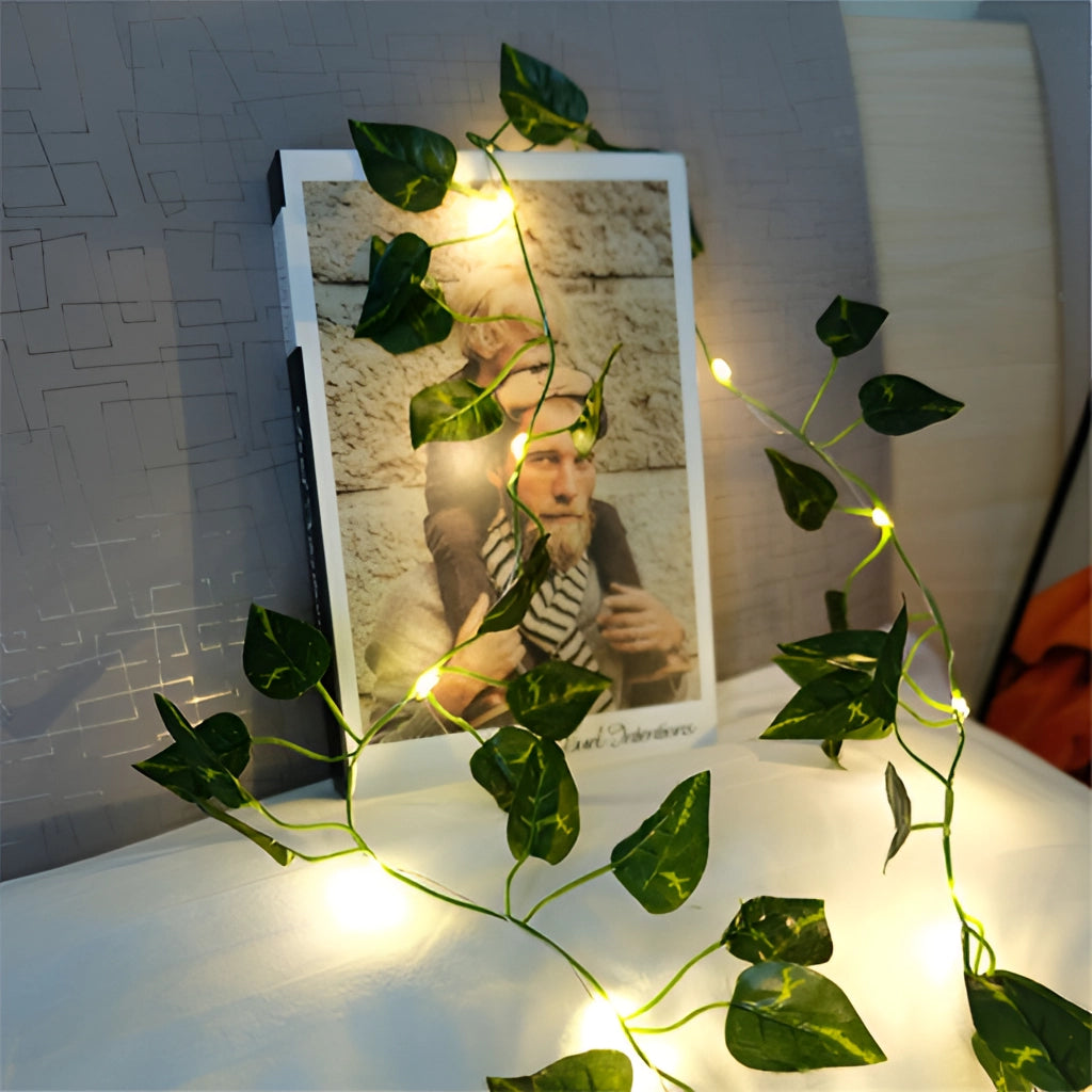LED vine garden string lights with ivy vines, 32ft with 100 LEDs, entwined with realistic ivy leaves, illuminating a cozy indoor setting with warm, ambient light.