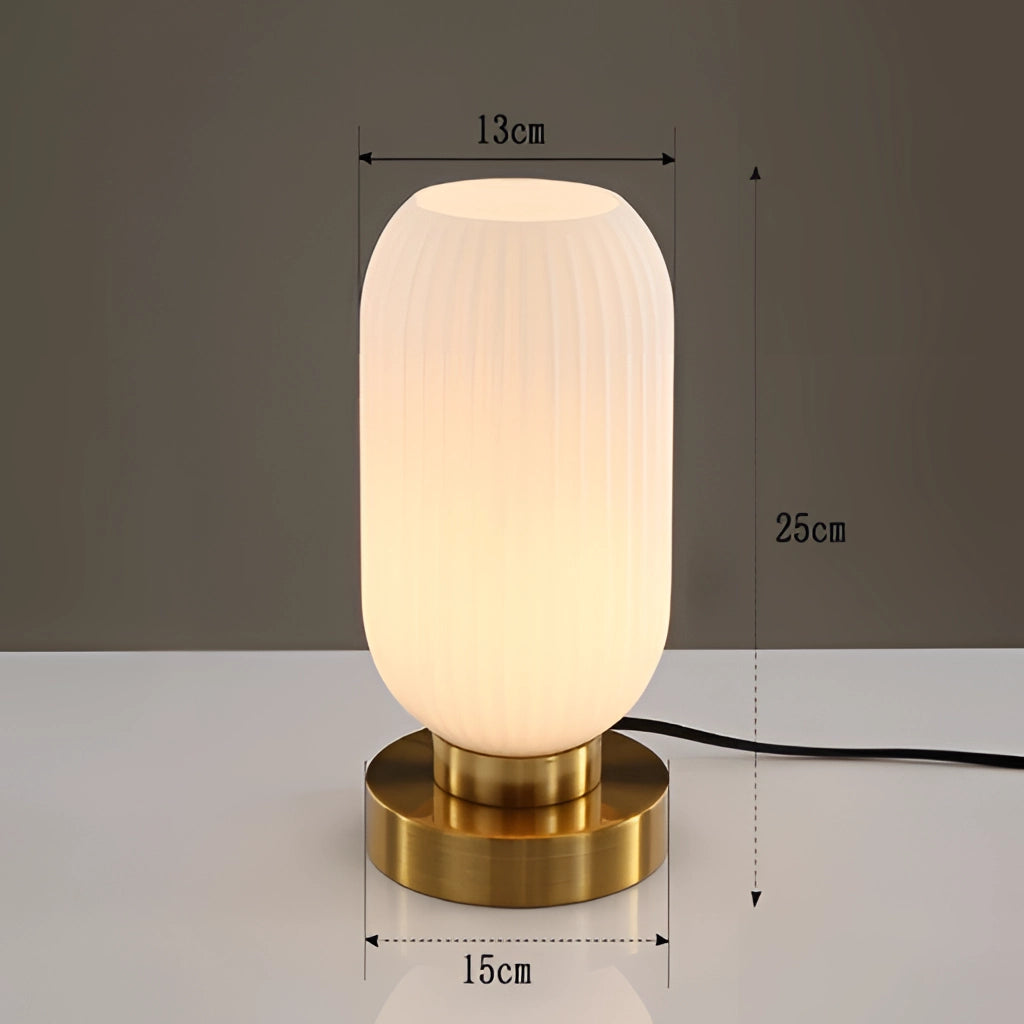 Luminescent Crystal Table Lamp in white, 13cm size, featuring a cylindrical shape with a rectangular base, glowing with fluorescent lighting, set on a wooden surface.