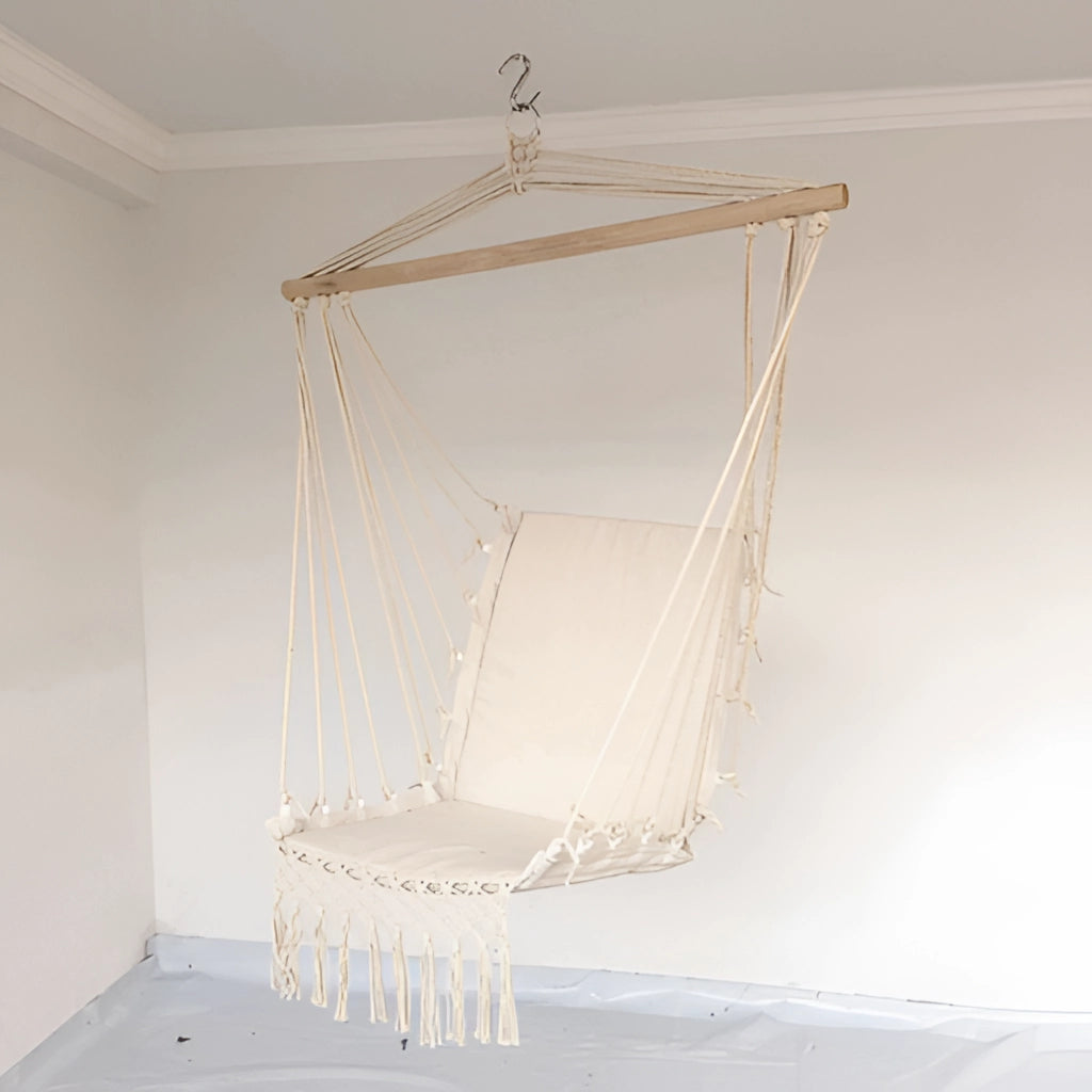 Macramé hammock swing hanging in a garden, featuring intricate woven patterns and wooden support.