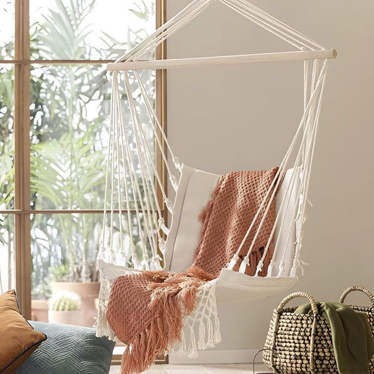 White macramé hammock swing for garden with wooden frame, featuring intricate textile patterns, providing comfort and shade.