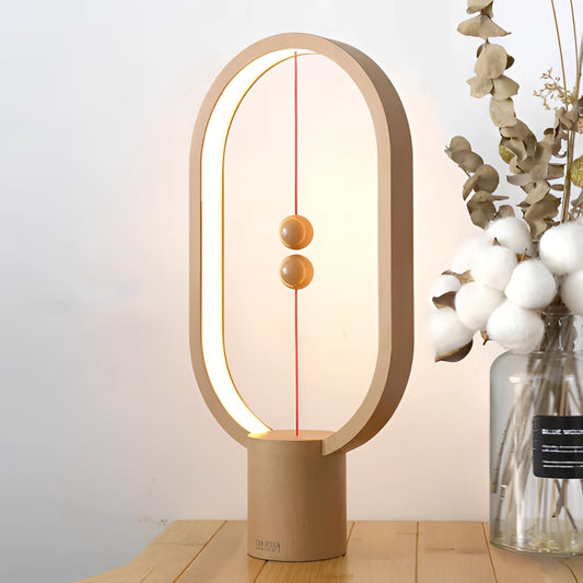 Magnetic balance table lamp with LED lighting featuring a rectangular wooden base, artistic design, and modern light fixture.