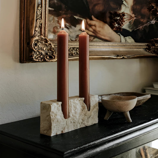Marble candle holder with a lit candle, placed on a wooden table, suitable for weddings and parties.