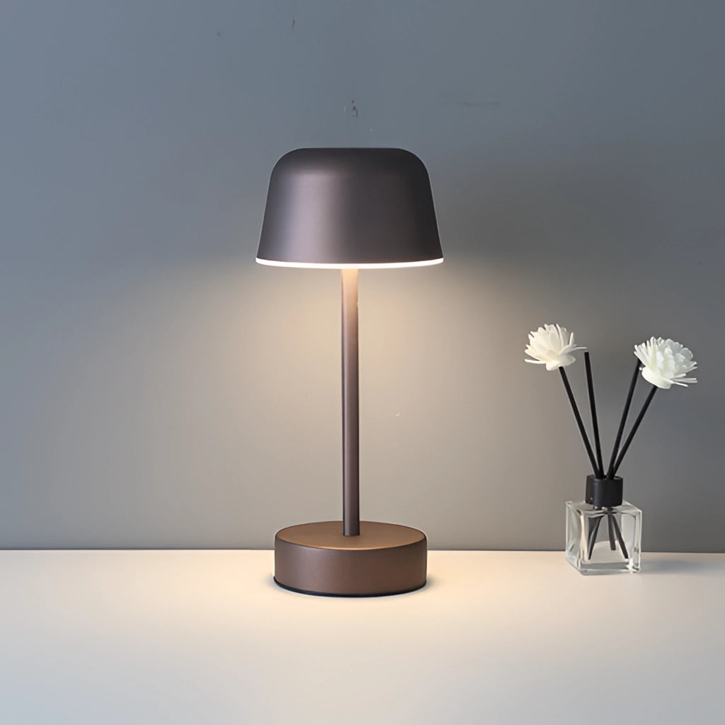 Metal Table Lamp with Adjustable Brightness in Coffee Finish on a Table Next to a Plant and Vase