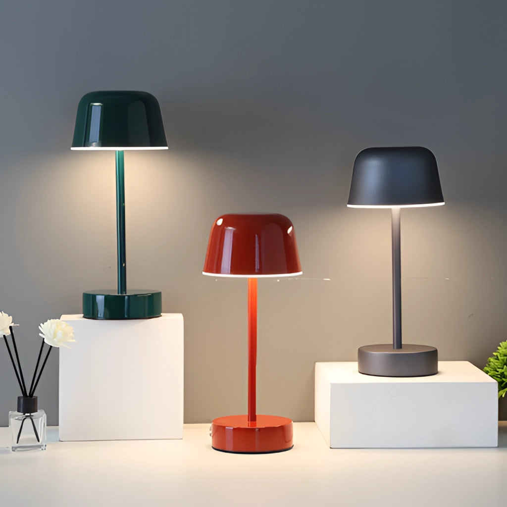 Metal table lamp with adjustable brightness, featuring a sleek grey finish, placed on wooden shelving in a modern interior design setting.