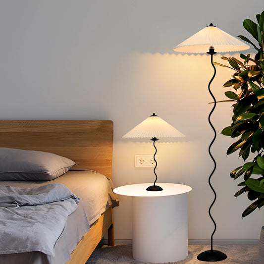 A stylish metal textile curved pleated floor lamp with a wooden base, designed for modern interior spaces and providing comfortable lighting.