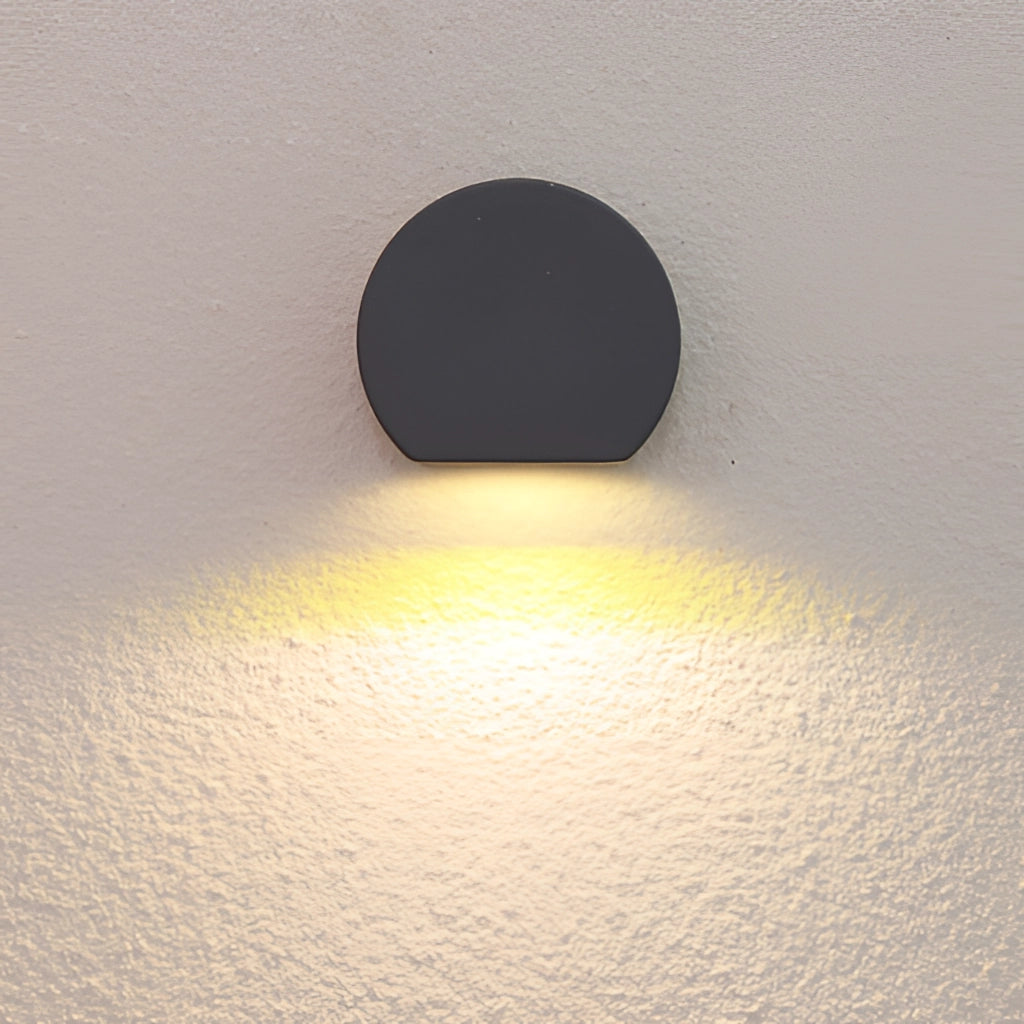Metal wall lamp LED sconce in sand black/grey, made of aluminum and borosilicate glass, mounted on a wall, with a sleek and modern design.