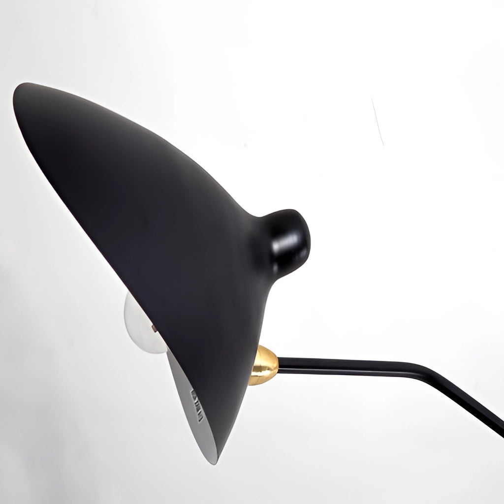 Midcentury floor lamp with tilting heads, sleek metal design, positioned in a bedroom setting.