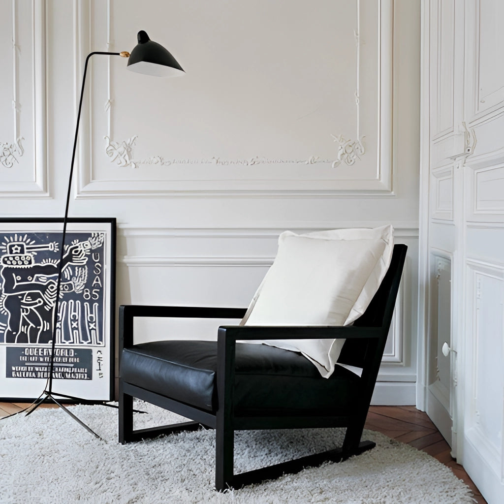 Midcentury floor lamp with tilting heads in a bedroom setting, featuring a sleek black design and wooden elements, placed next to a chair and door.
