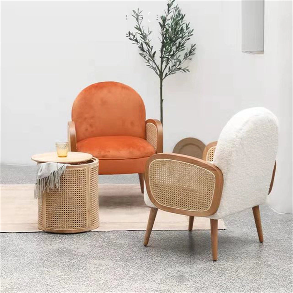 Orange modern club chair with armrests and wooden legs, placed in a stylish indoor setting next to a potted plant.