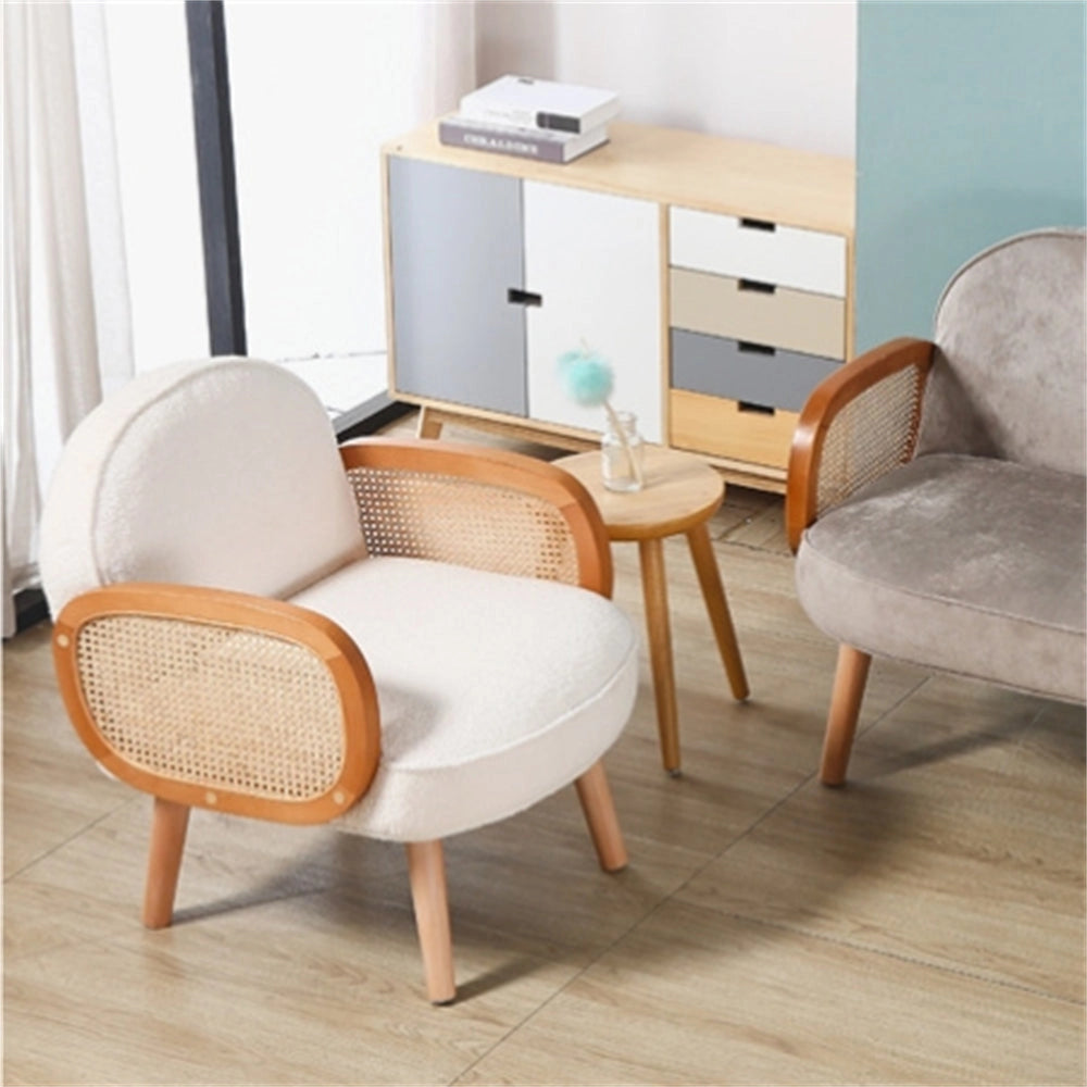 White modern club chair with wooden legs placed on a wooden floor.