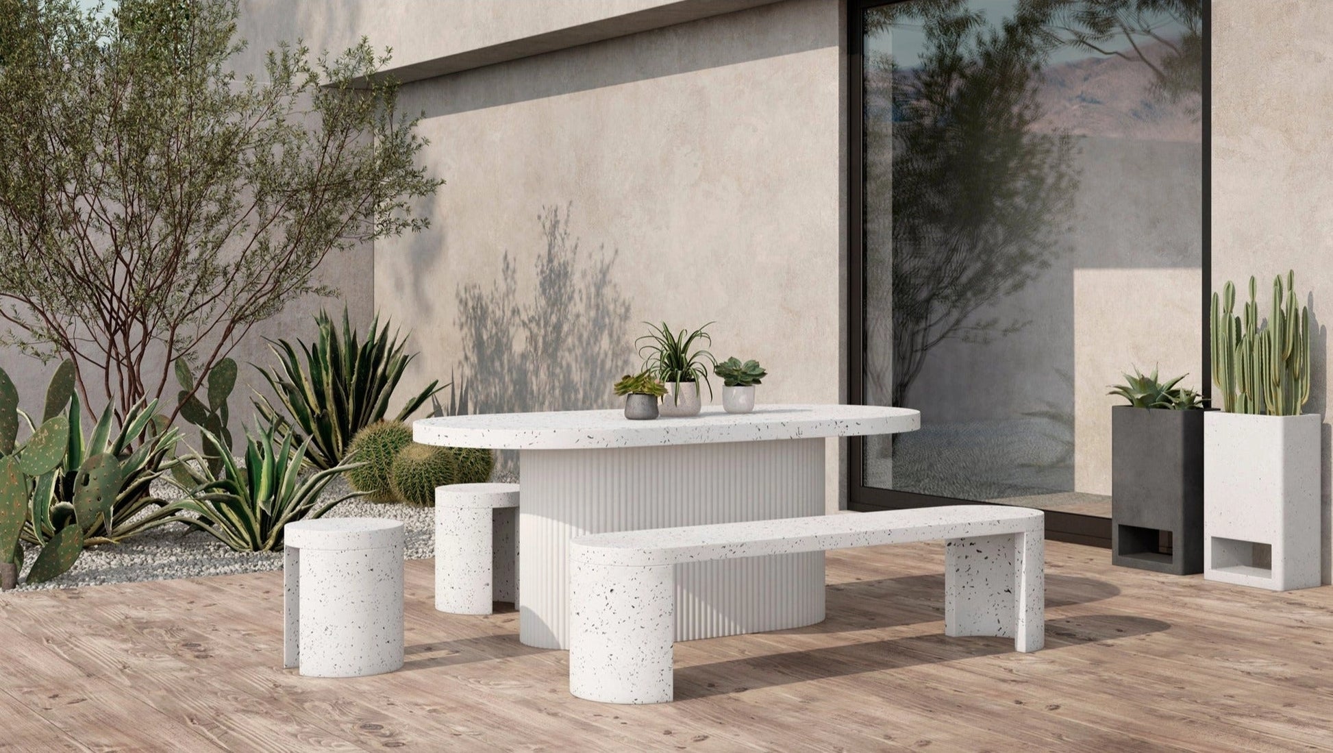 Modular ivory terrazzo garden planter with a rectangular shape, placed on a wooden table in an outdoor setting.