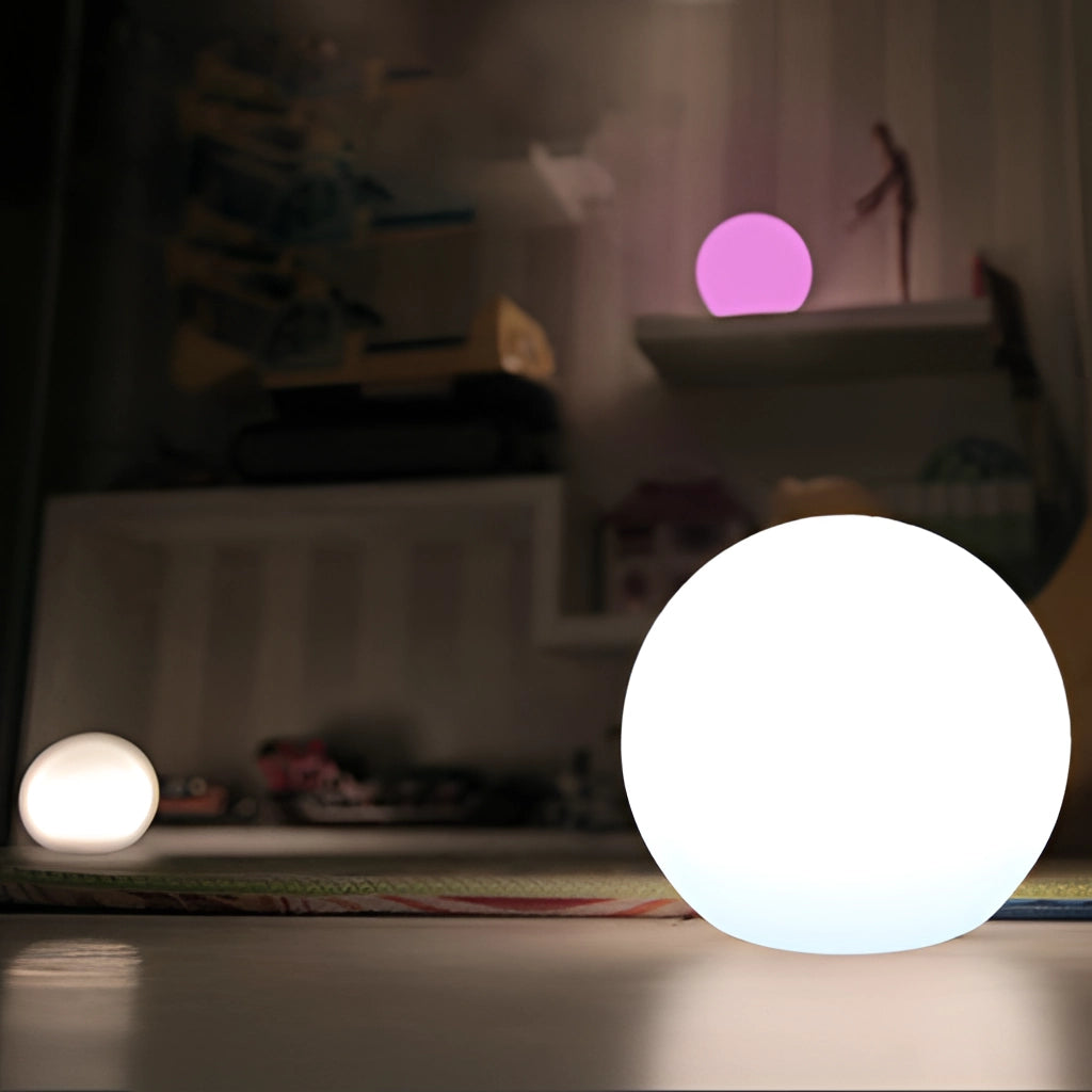 Moon Cordless LED Table Lamp with Color Control illuminating a dimly lit room with a wooden floor and ceiling.
