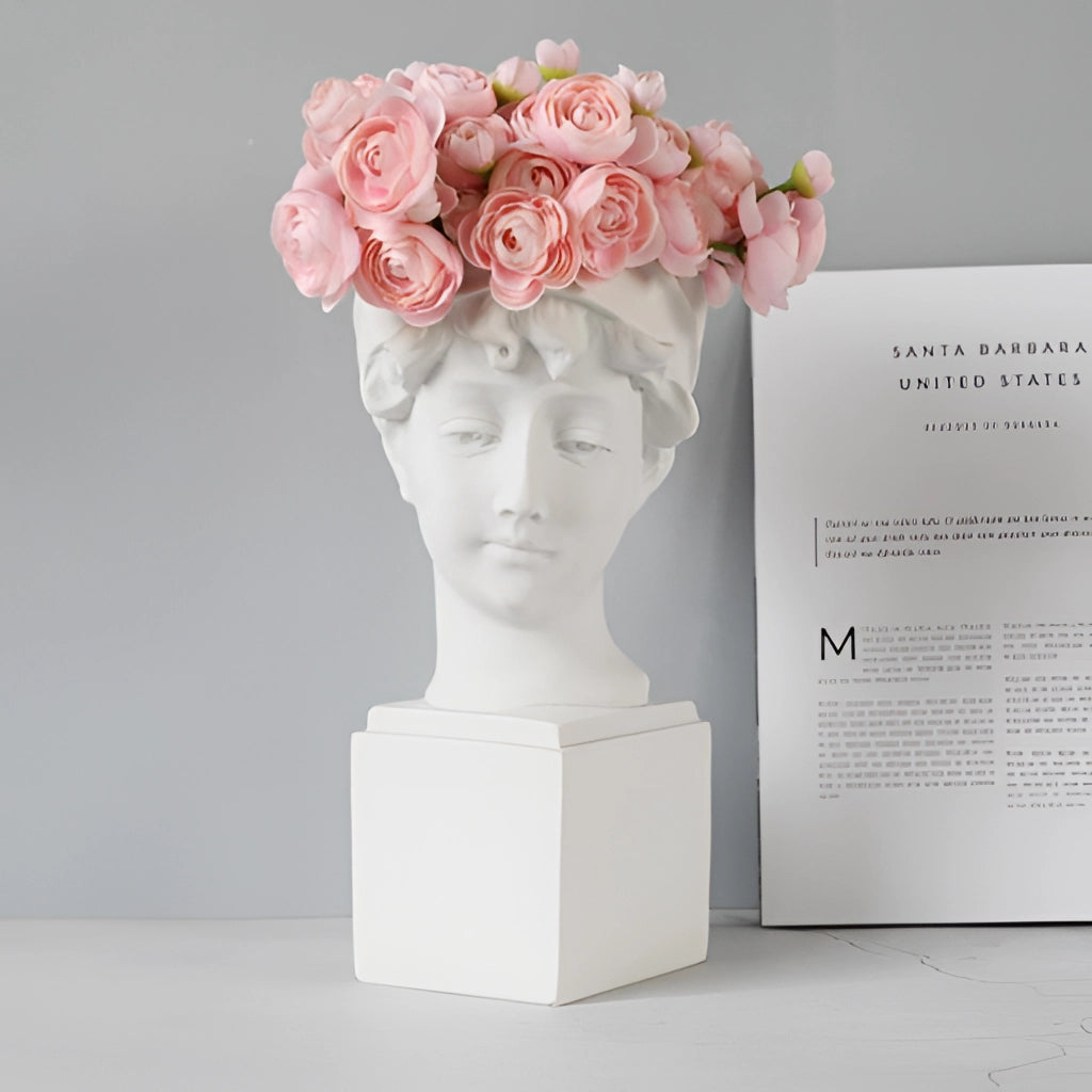 Neoclassical Greek head resin vase with blooming flowers inside, styled as a decorative planter.