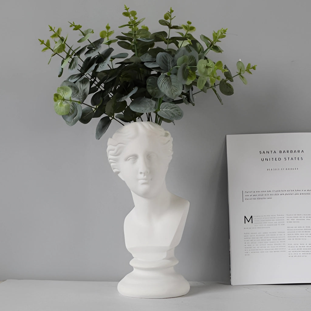 Neoclassical Greek head resin vase used as a planter, featuring intricate sculpture details and a houseplant.