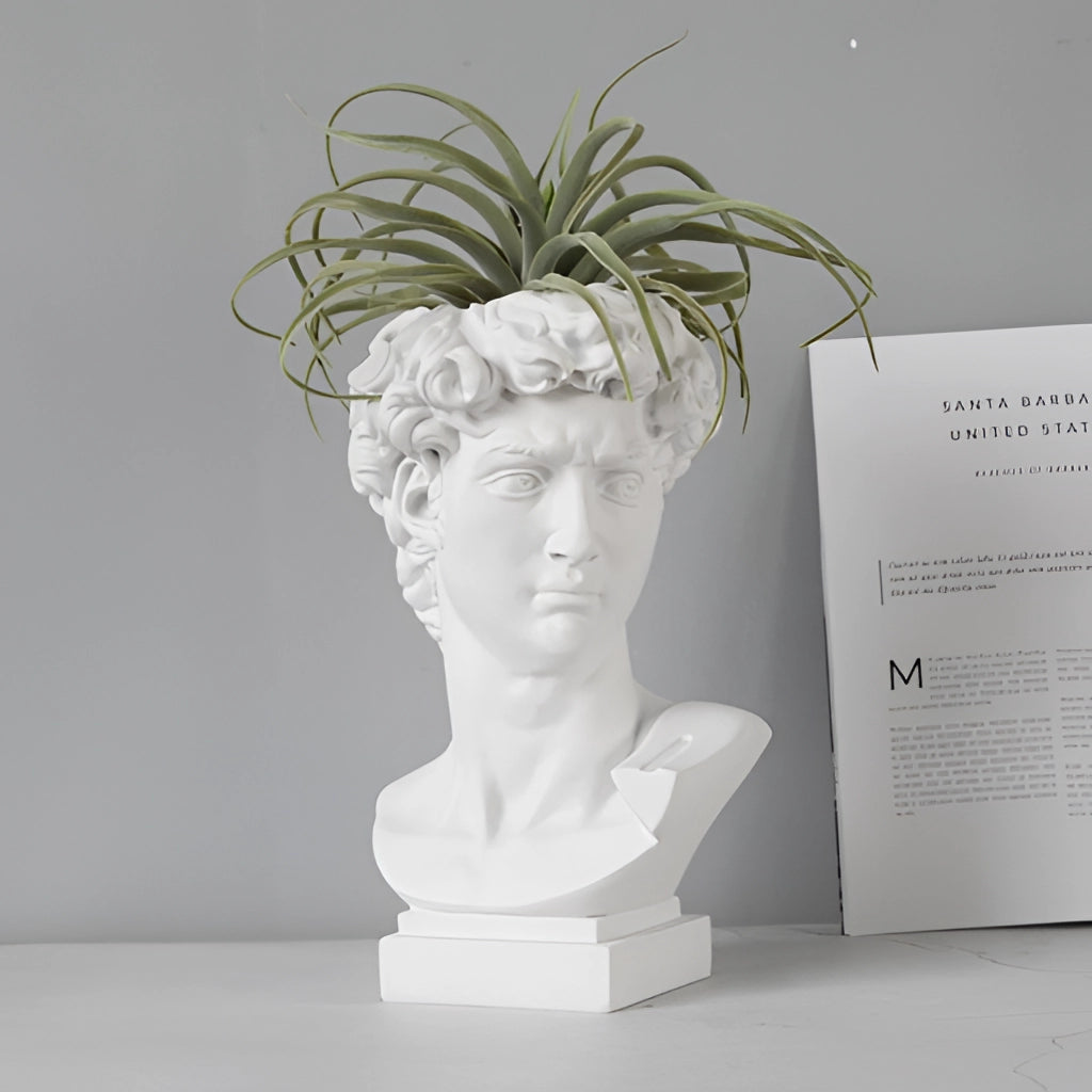Neoclassical Greek head resin vase used as a planter with a terrestrial plant.