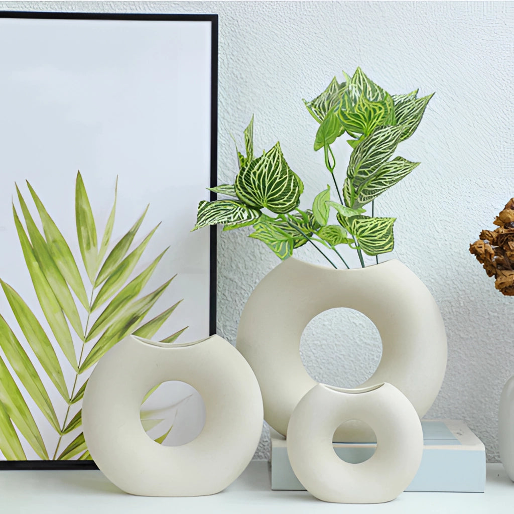 Nordic style ceramic donut vase with modern circular design, displayed on a shelf with a small houseplant.