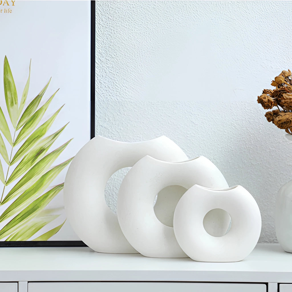 Nordic Style Ceramic Donut Vase with Modern Circular Design placed in an office or living room setting with minimalist interior decor.