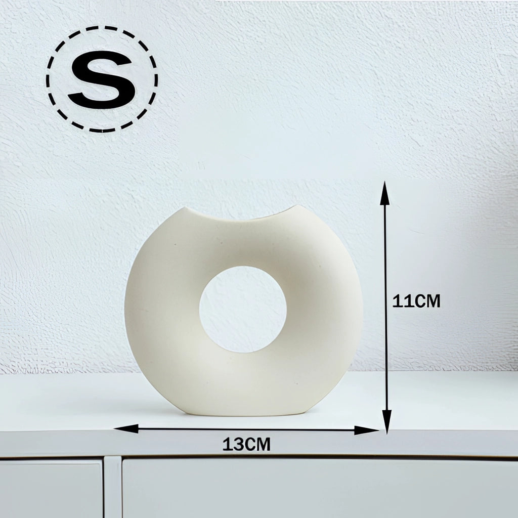Nordic style ceramic donut vase with modern circular design, displayed in an office or living room setting.