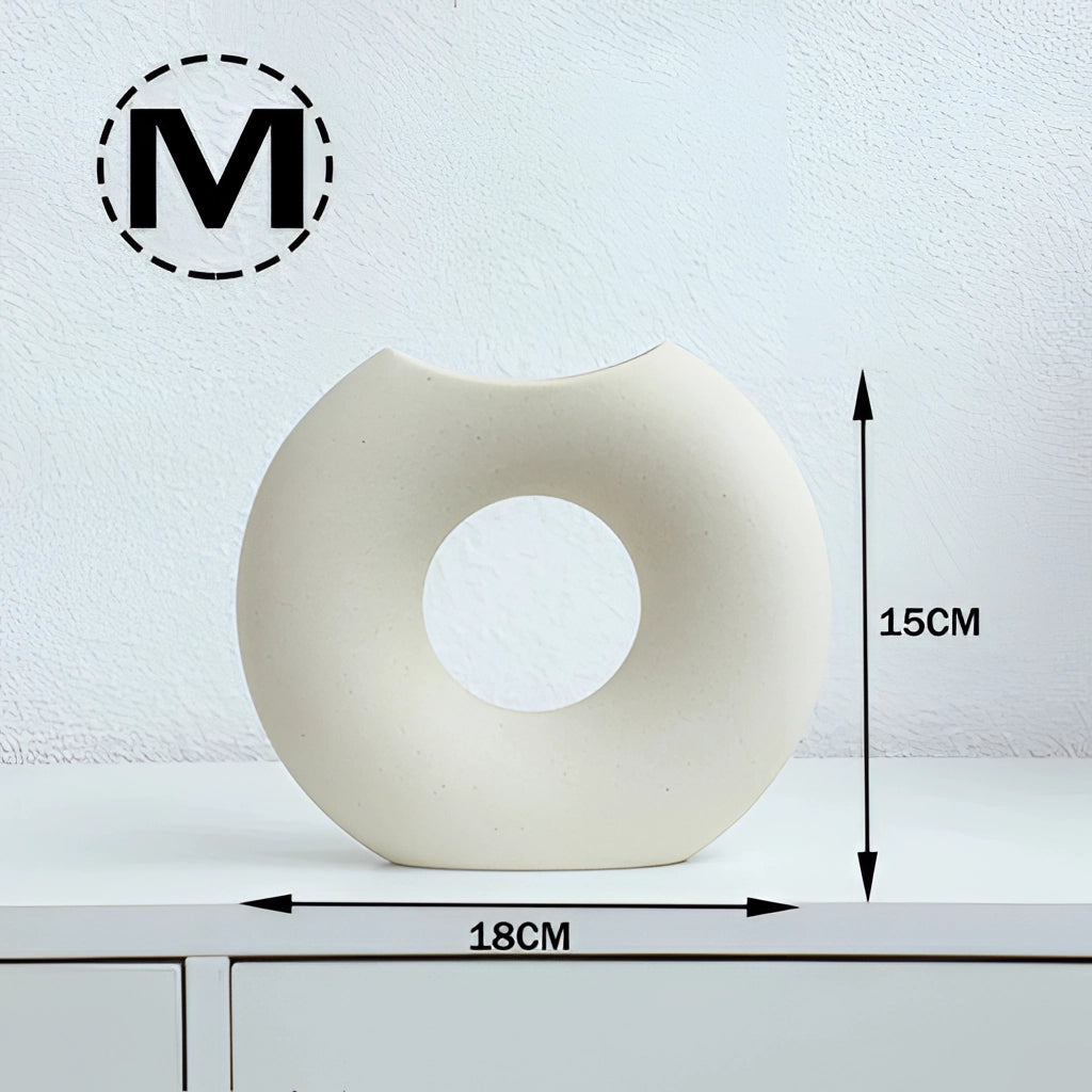 Nordic Style Ceramic Donut Vase with modern circular design placed against a minimalist wall, ideal for office and living room decor.