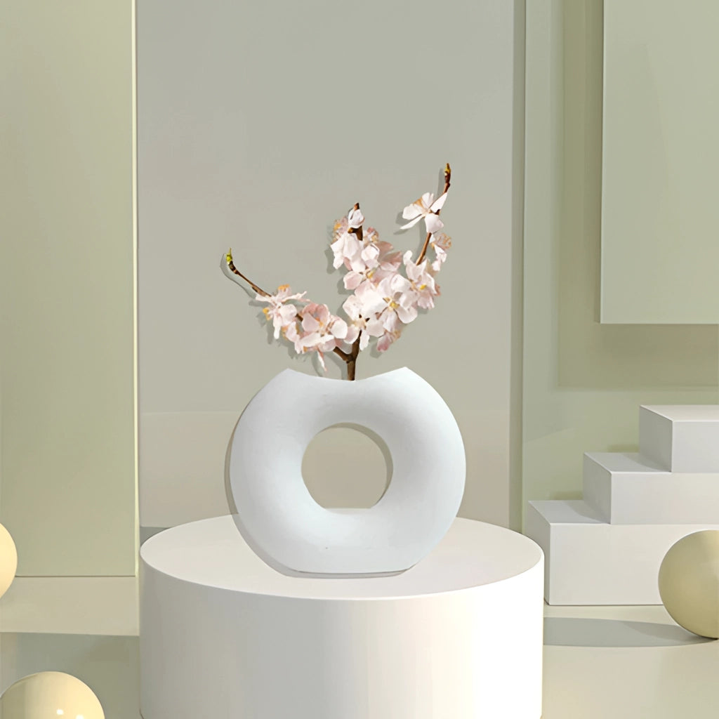 Nordic style ceramic donut vase with a modern circular design, displayed in a minimalist interior setting.